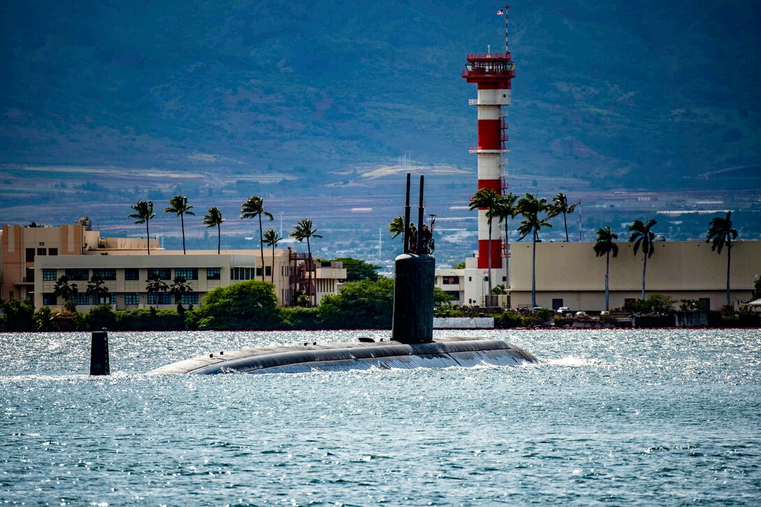 A submarine travels in water as palm trees wave in the breeze