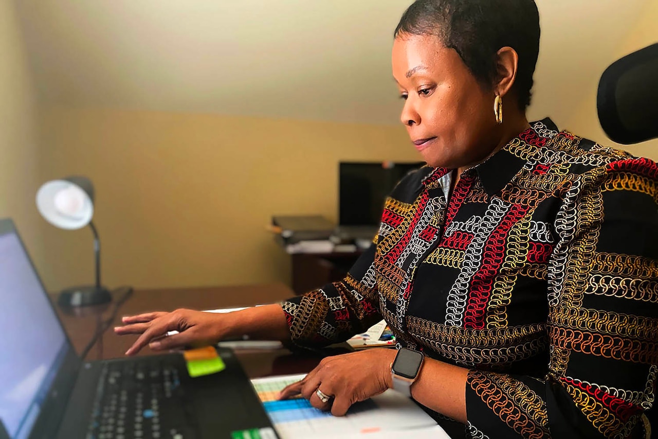 A woman works on a laptop.