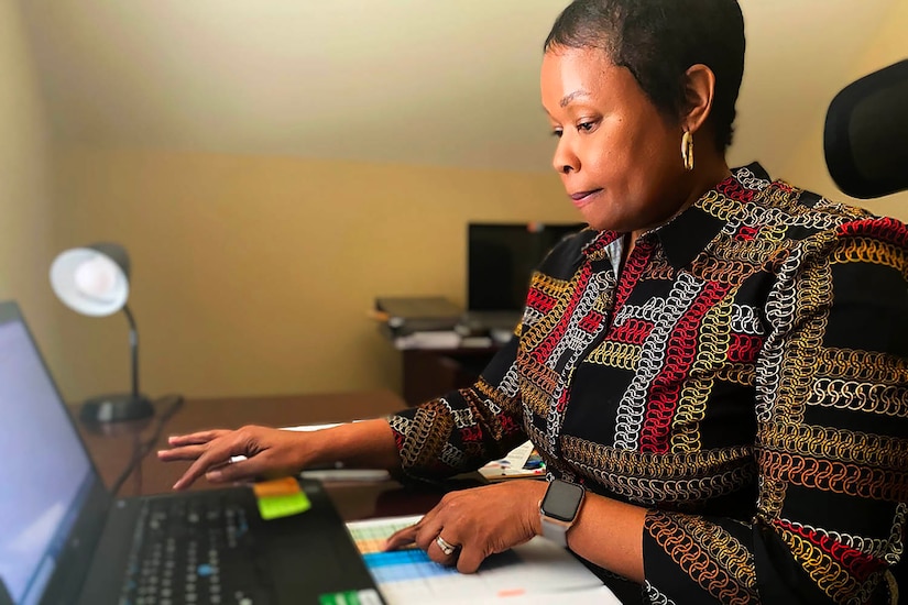 A woman works on a laptop.