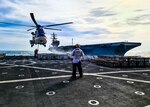 Civilian mariners assigned to the Lewis and Clark-class dry cargo and ammunition ship USNS Carl Brashear (T-AKE 7) attach supplies to Carl Brashear’s AS-332 Super Puma helicopter during a replenishment-at-sea with the forward-deployed aircraft carrier USS Ronald Reagan (CVN 76).