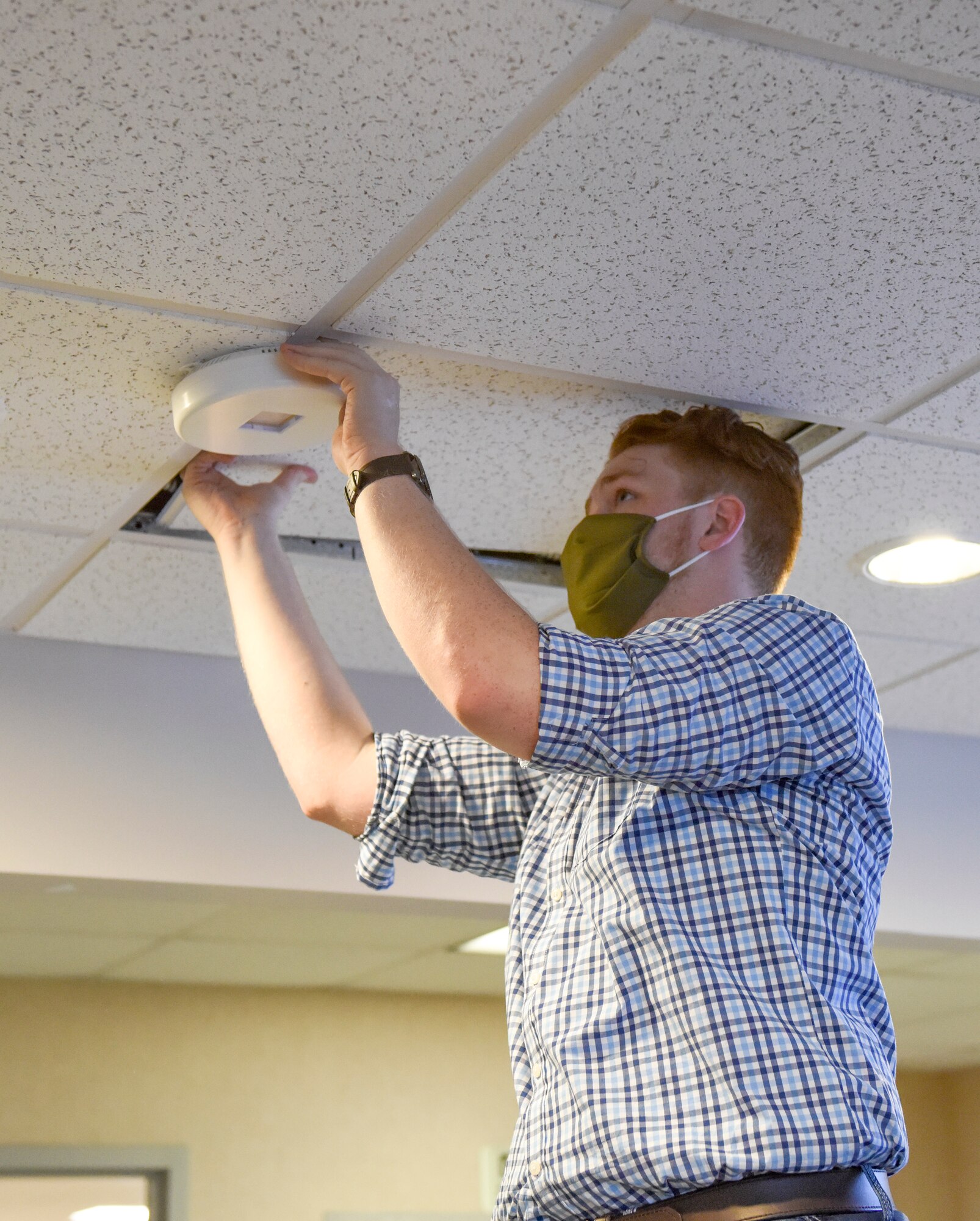 Jordan, a field engineer for FAR UV Technologies, installs an ultraviolet light in the 189th Operations Group ceiling July 16, 2020, at Little Rock Air Force Base, Ark. The UV lighting is environmentally-friendly and mercury-free.