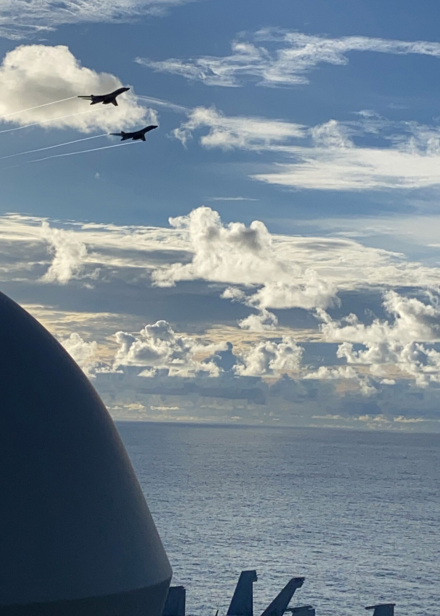 U.S. Air Force B-1B Lancers fly by the USS Ronald Reagan in the Philippine Sea during a Bomber Task Force mission, July 21, 2020. Strategic bomber missions contribute to the joint lethality and readiness of the U.S. Air Force and its allies and partners throughout the Indo-Pacific region. (Courtesy Photo by U.S. Navy)