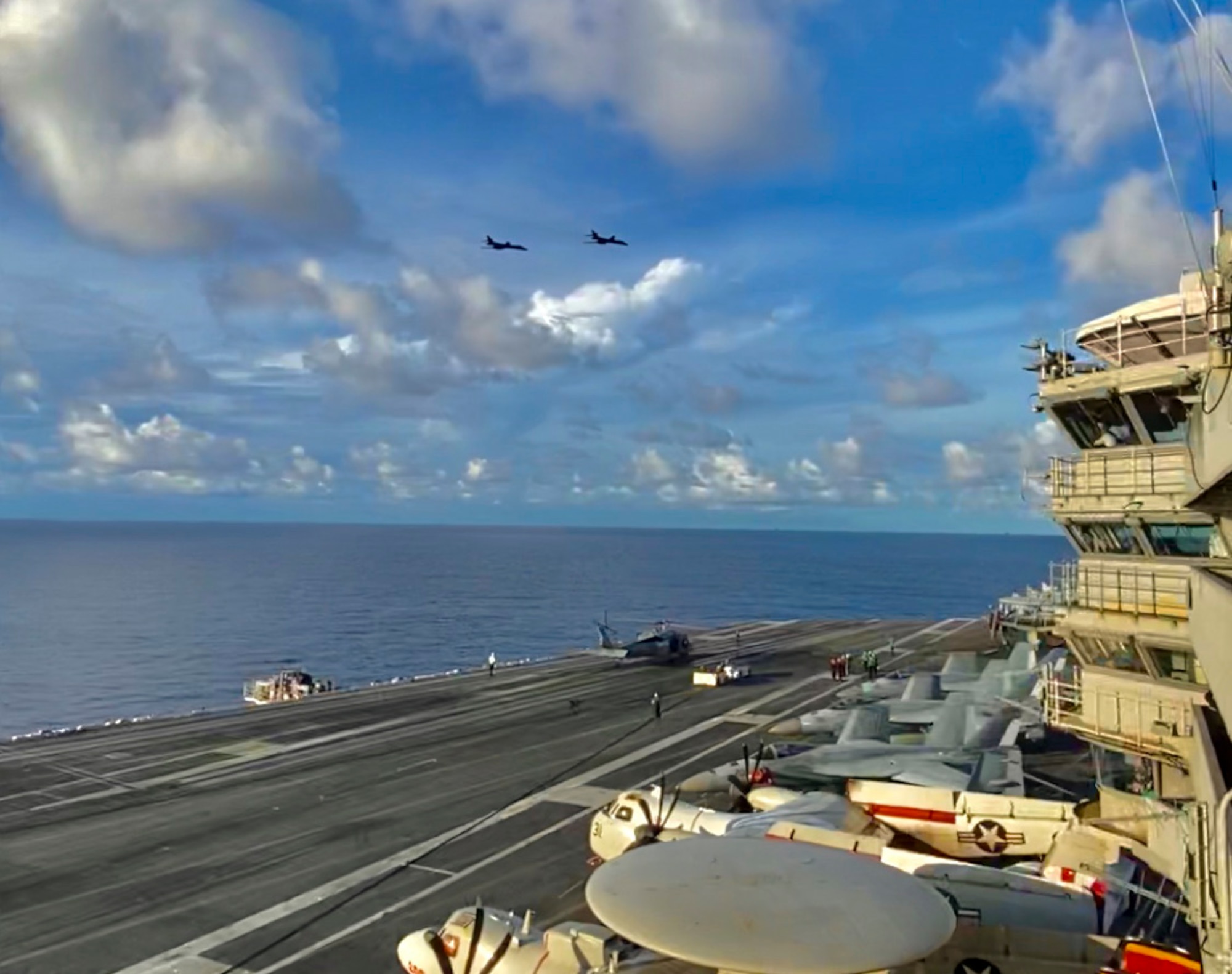 U.S. Air Force B-1B Lancers fly by the USS Ronald Reagan Carrier Strike Group in the Philippine Sea during a Bomber Task Force mission, July 21, 2020. Strategic bomber missions contribute to the joint lethality and readiness of the U.S. Air Force and its allies and partners throughout the Indo-Pacific region. (Courtesy Photo by U.S. Navy)