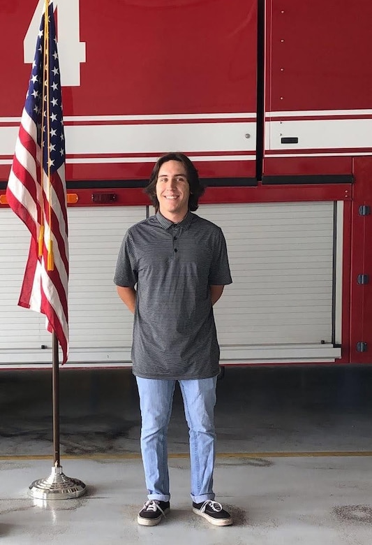 Connor Tabarini stands in front of a fire engine at the Idaho Air National Guard’s Gowen Field, after enlisting as a fireman in the Air Force Reserve.