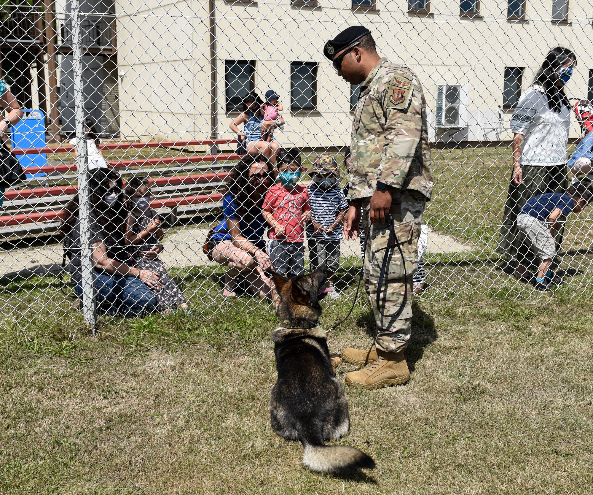 U.S. Air Force Tech. Sgt. Dontae Stamps, 52nd Security Forces Squadron military working dog handler, and Axel, an MWD, interact with children and families at Spangdahlem Air Base, Germany, July 22, 2020. Stamps answered any questions Spangdahlem AB families had about handling an MWD and their training. (U.S. Air Force photo by Senior Airman Melody W. Howley