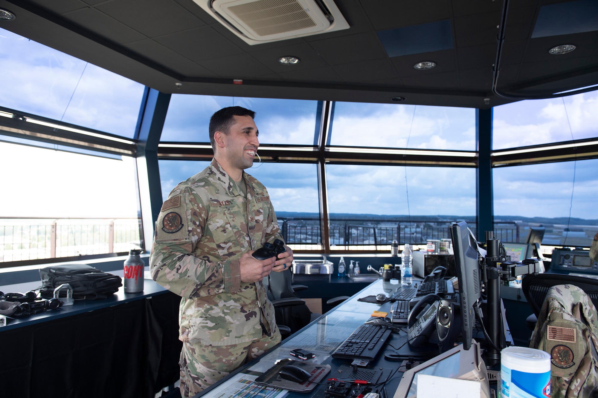 U.S. Air Force Tech. Sgt Erron Sayas, 52nd Operational Support Squadron air traffic control watch supervisor, looks out of the air traffic control tower at Spangdahlem Air Base, Germany, July 17, 2020. Sayas earned a nomination for the Chainbreaker Award for his actions in preventing a disaster on the flightline between a C-17 Globemaster III and a flightline sweeper vehicle. (U.S. Air Force photo by Airman 1st Class Alison Stewart)