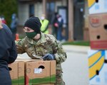 Michigan Soldiers from the 126th Army Band, Michigan Army National Guard assist Feeding American West Michigan Food Bank by distributing food for families in need during a recent mobile food distribution event as part of the Michigan National Guard's coronavirus 19 disease (COVID-19) response.