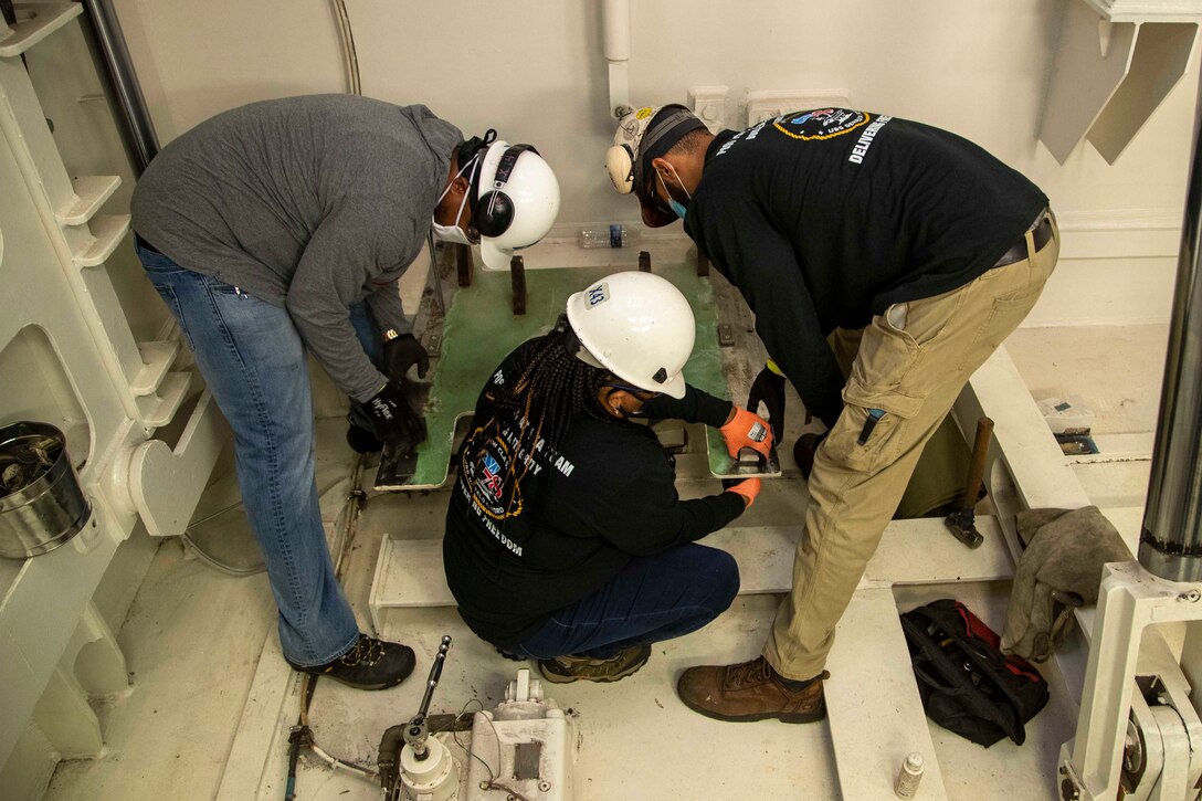 Newport News Shipbuilding (NNS) workers install a sliding cover in USS Gerald R. Ford's (CVN 78) advanced weapons elevator (AWE) 1, July 18, 2020.