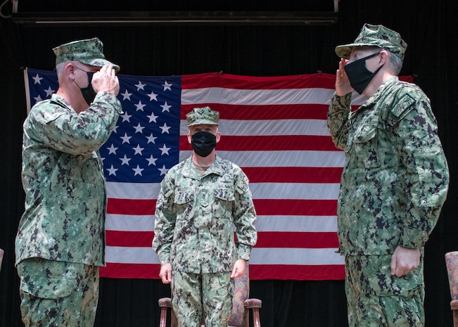 200723-N-KZ419-1003 NAVAL SUPPORT ACTIVITY BAHRAIN (July 23, 2020) – Capt. Price Lockard, left, salutes Capt. James Johnston, right, in a change of command ceremony for Commander, Task Force 57 presided over by Vice Adm. Jim Malloy, commander U.S. Naval Forces Central Command, U.S. 5th Fleet and Combined Maritime Forces, center on Naval Support Activity Bahrain. The 5th Fleet area of operations encompasses about 2.5 million square miles of water area and includes the Arabian Gulf, Gulf of Oman, Red Sea and parts of the Indian Ocean. The expanse is comprised of 20 countries and includes three chokepoints, critical to the free flow of global commerce. (U.S. Navy photo by Mass Communication Specialist 3rd Class Dawson Roth)