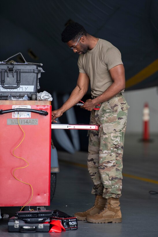 Staff Sgt. Ridge Rozier, 100th Maintenance Squadron noncommissioned officer in charge of hydraulics back shop, retrieves a tool while conducting maintenance on the flying boom of a KC-135 Stratotanker at RAF Mildenhall, England, July 17, 2020. Tool accountability ensures no foreign object debris remains in the aircraft after the completion of maintenance. (U.S. Air Force photo by Airman 1st Class Joseph Barron)