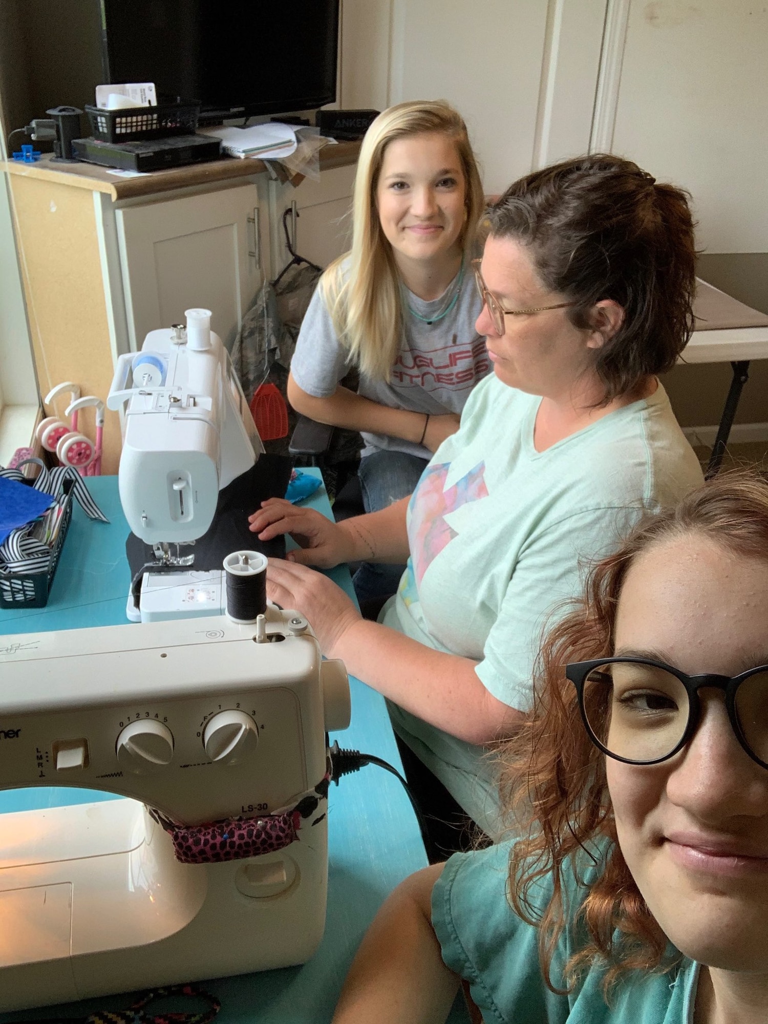 Donna Cleveland and her daughters, Lia and Lexi, sew face masks at their home in Union, Mississippi.