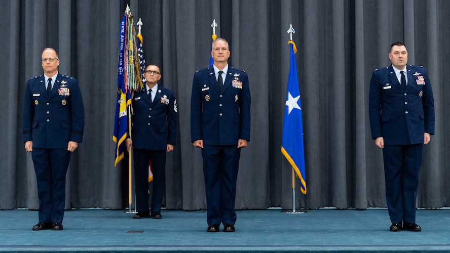 Maj. Gen. Mark E. Weatherington, 8th Air Force and Joint-Global Strike Operations Center commander, Col. Michael A. Miller, outgoing 2nd Bomb Wing commander, and Col. Mark C. Dmytryszyn, incoming 2nd BW commander, stand at the position of attention during a change of command ceremony at Barksdale Air Force Base, La., July 23, 2020. A change of command is a military tradition that represents a formal transfer of authority and responsibility for a unit from one commanding or flag officer to another. (U.S. Air Force photo by Airman 1st Class Jacob B. Wrightsman)