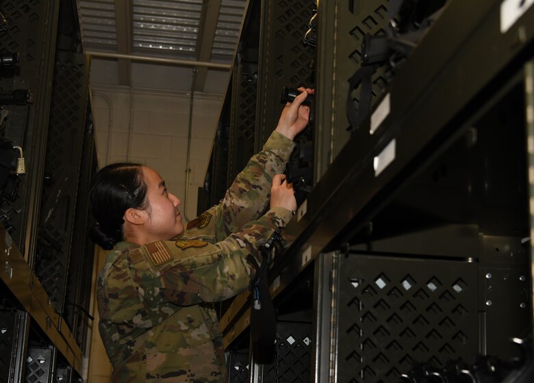 A photo of an Airman grabbing a weapon.