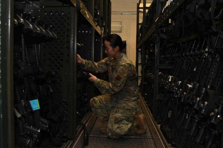 A photo of an Airman grabbing a weapon.