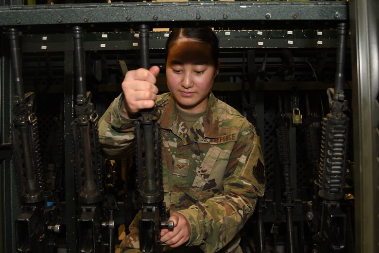 A photo of an Airman grabbing a weapon.