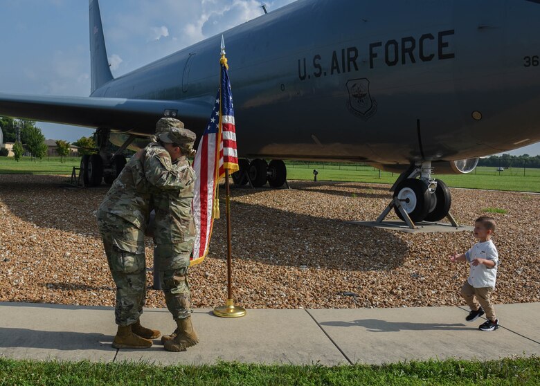 Capt Morgan Bielecki and Staff Sgt. Taylor Ray share a hug after Ray's re-enlistment ceremony.