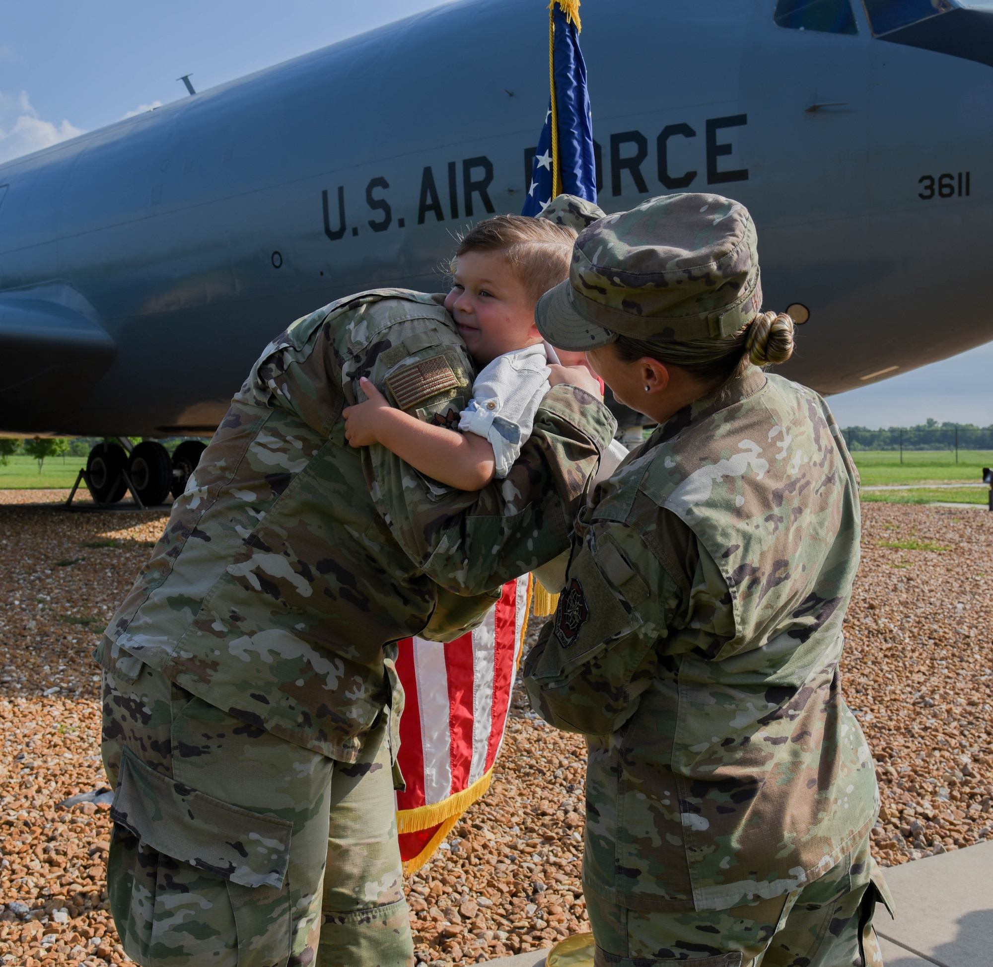 Staff Sgt. Taylor Ray helps her son, Liam, give Capt Morgan Bielecki a hug.