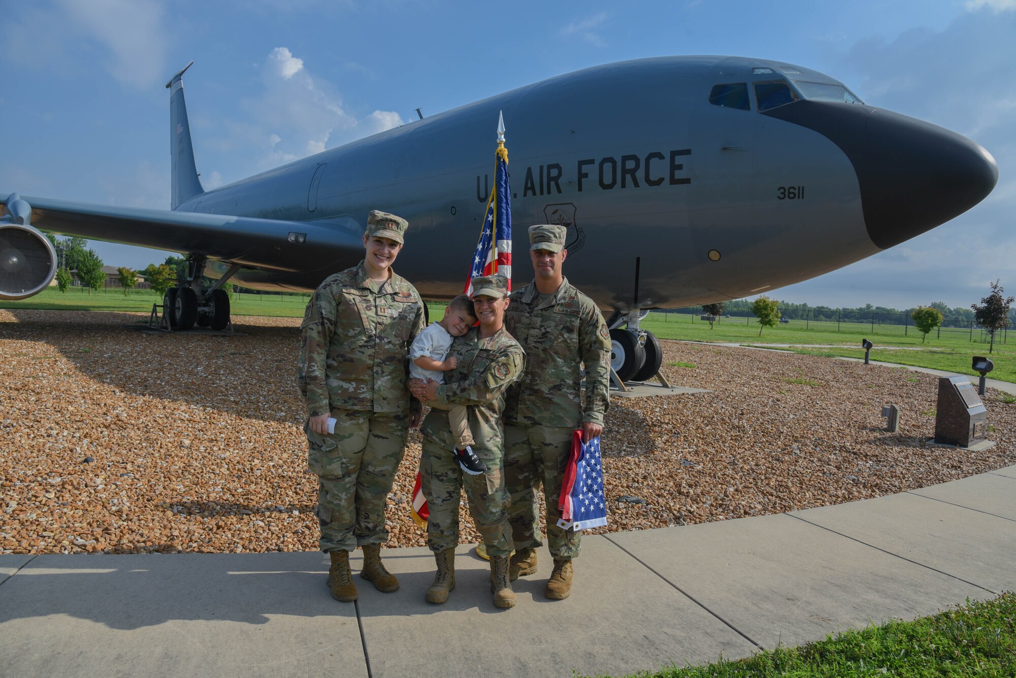 Capt Morgan Bielecki, Staff Sgt Taylor Ray, Master Sgt. Scott Ray and their son, Liam Ray pose after Staff Sgt Ray's re-enlistment ceremony.