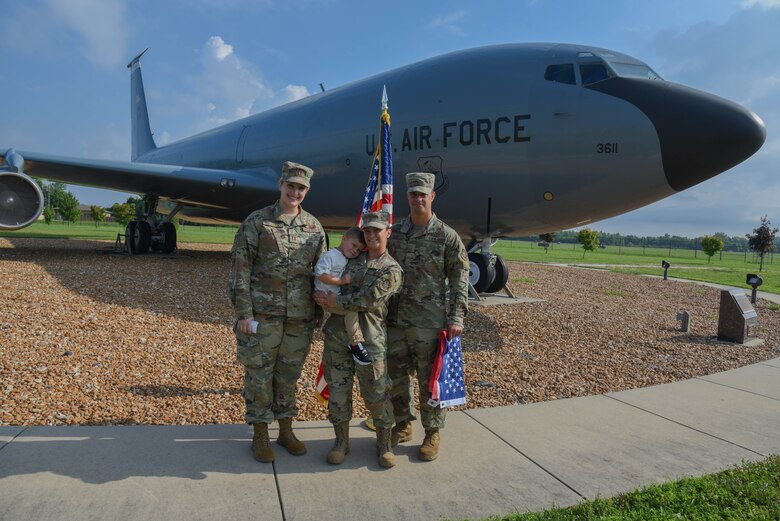 Capt Morgan Bielecki, Staff Sgt Taylor Ray, Master Sgt. Scott Ray and their son, Liam Ray pose after Staff Sgt Ray's re-enlistment ceremony.