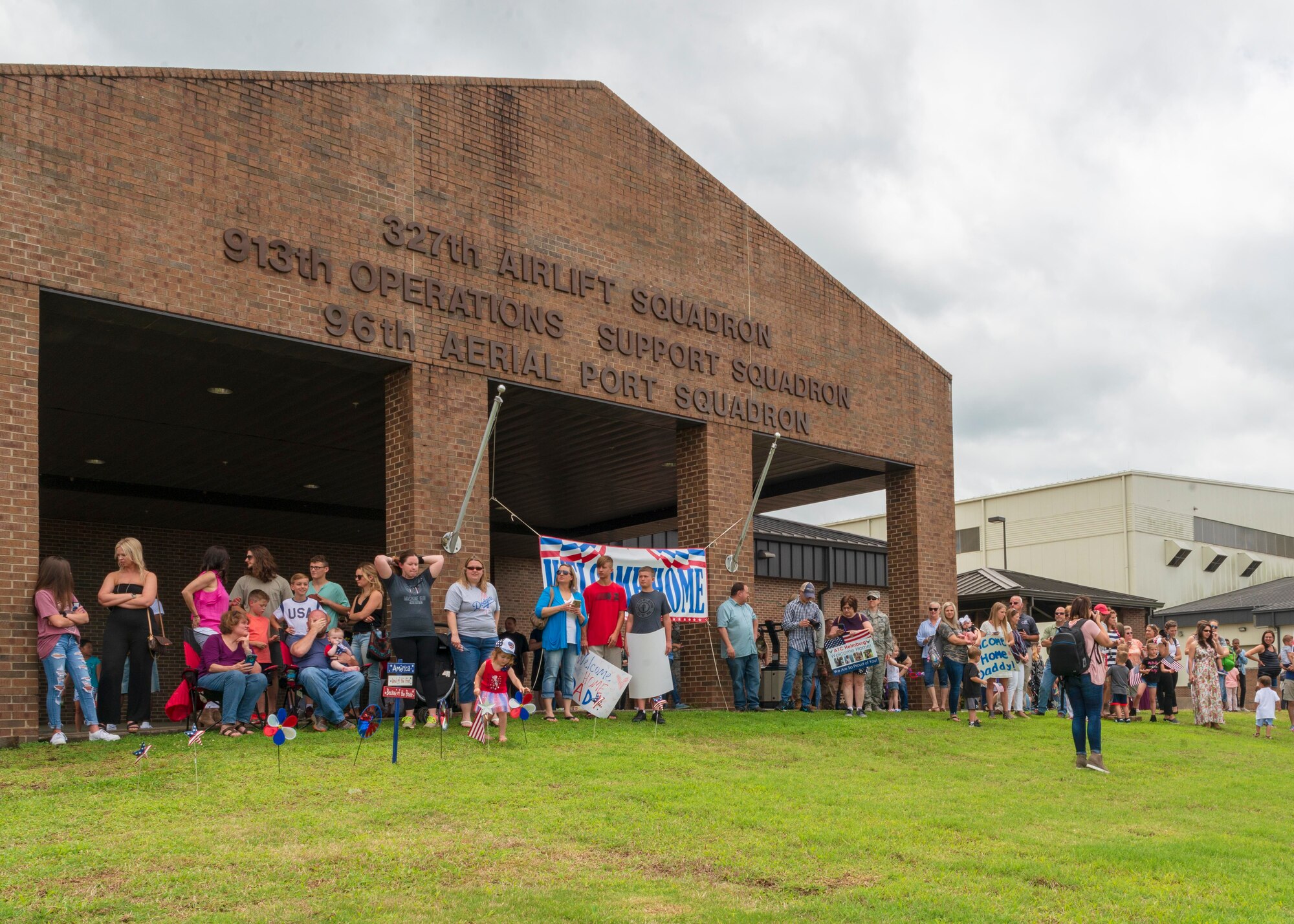 Family members of 913th Airlift Group gather at back of the 327th Airlift Squadron to greet returning Reserve Citizen Airmen at Little Rock Air Force Base, Arkansas, May 19, 2019. The Key Spouse program provided care packages to the military members during the deployment and continue to provide resources to family members.  (U.S. Air Force Reserve photo by Maj. Ashley Walker)