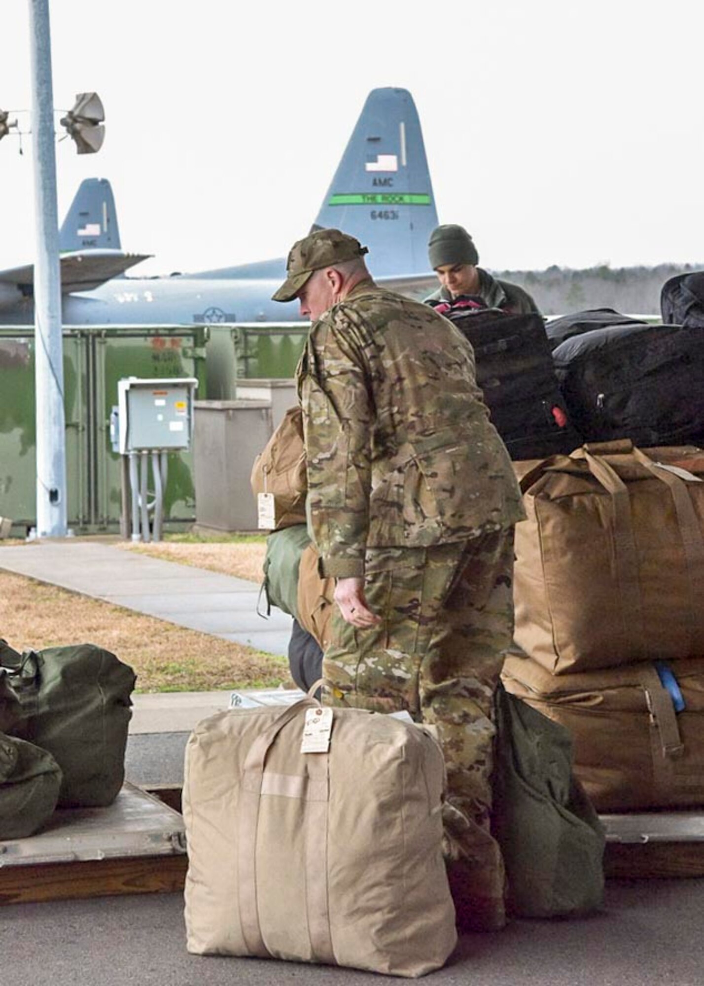 Lt. Col. Scott Lawson, 913th Airlift Group chief of safety, places his luggage on top of a cargo pallet to be loaded onto a C-130J at Little Rock Air Force Base, Ark., on Jan. 28, 2019.  The 913th Airlift Group airlift and maintenance personnel deployed together to provide combat airlift to support Operations Inherent Resolve, New Dawn, and Freedom’s Sentinel.  Nearly 80 percent of the unit are traditional reservists who live across the state and train one weekend a month, two-weeks a year.  (U.S. Air Force Reserve photo by Maj. Ashley Walker)