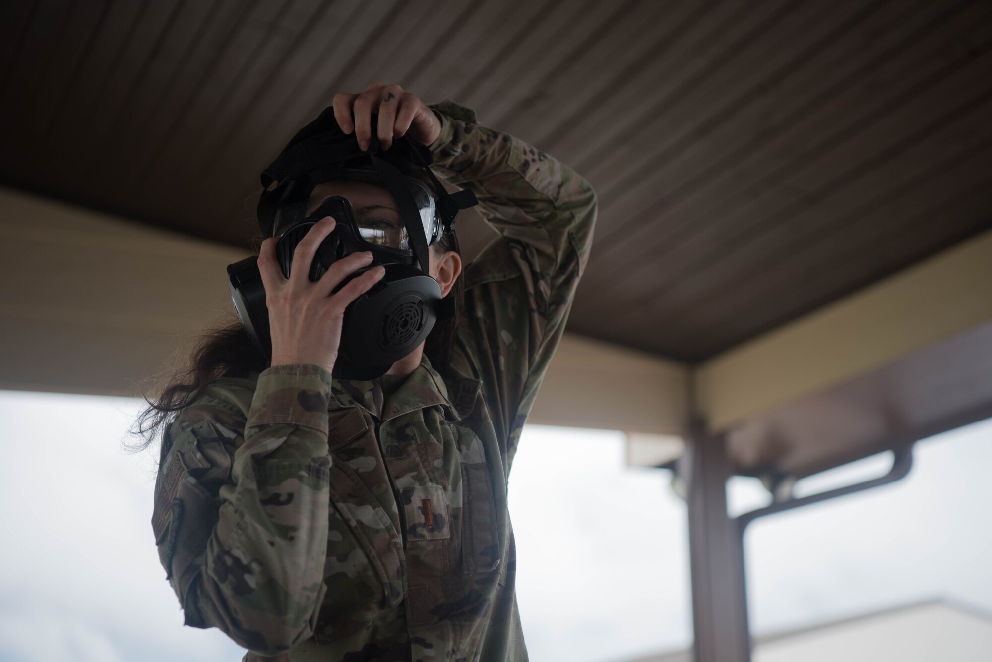 2nd Lt. Kaitlyn Danner, 22nd Air Refueling Wing public affairs chief of media, dons an M50 gas mask during a Chemical, Biological, Radiological and Nuclear survival skills training July 21, 2020, at McConnell Air Force Base, Kansas. The CBRN requirements are necessary to ensure that all Airmen are deployment-ready. (U.S. Air Force photo by Senior Airman Alexi Bosarge)