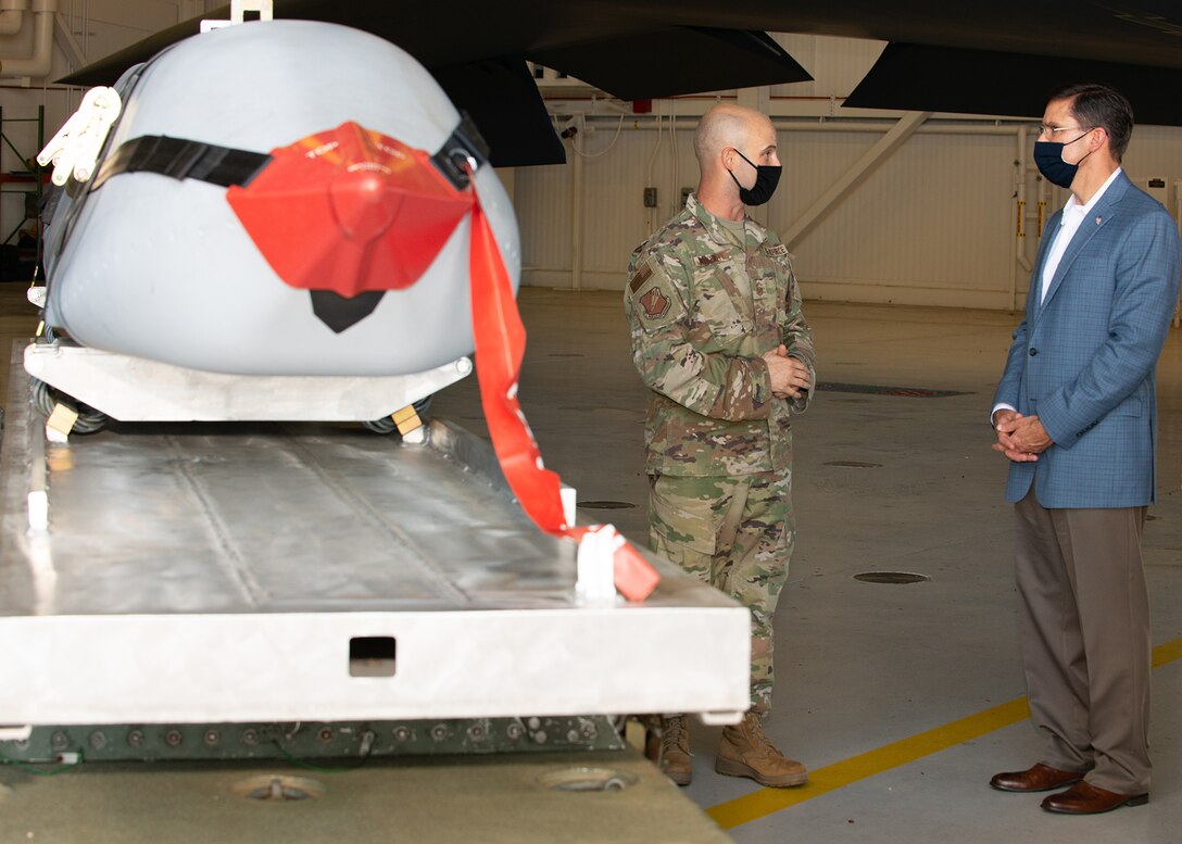 U.S. Secretary of Defense, Dr. Mark T. Esper, speaks with Senior Master Sgt. John Burkhart, 131st Munitions Flight Chief,  during a visit at Whiteman Air Force Base, Missouri, July 22, 2020. During his visit, Esper received an in-person introduction to various aspects of Team Whiteman's mission, total force integration between the active duty and Air National Guard wings, and ensuring the B-2 Spirit stealth bomber's combat readiness during COVID-19. (U.S. Air Force photo by Senior Airman Thomas Barley)