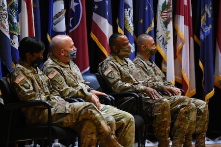 four soldiers sitting in a line.