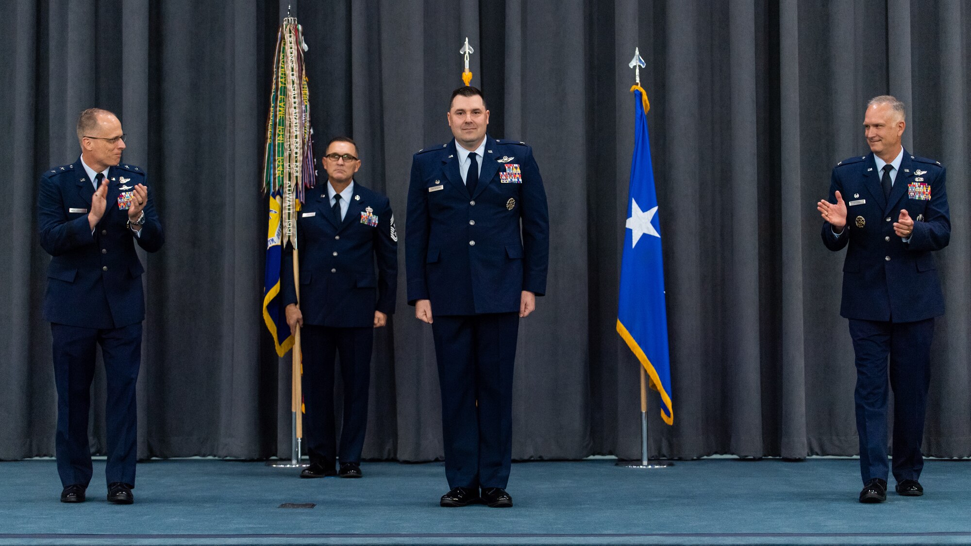 Maj. Gen. Mark E. Weatherington, left, 8th Air Force and Joint-Global Strike Operations Center commander, and Col. Michael A. Miller, right, outgoing 2nd Bomb Wing commander, congratulate Col. Mark C. Dmytryszyn, middle, incoming 2nd BW commander, during a change of command ceremony at Barksdale Air Force Base, La., July 23, 2020. A change of command is a military tradition that represents a formal transfer of authority and responsibility for a unit from one commanding or flag officer to another. (U.S. Air Force photo by Airman 1st Class Jacob B. Wrightsman)