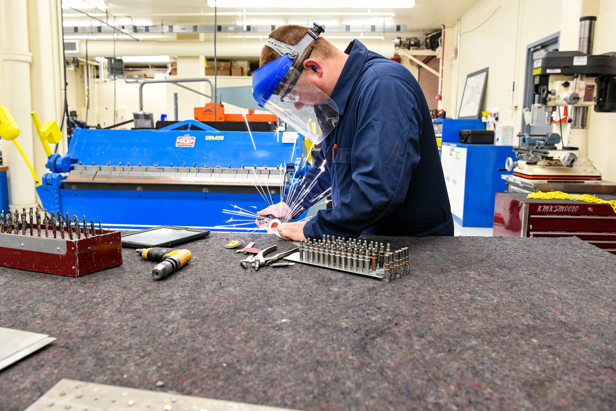 Airmen shaping metal