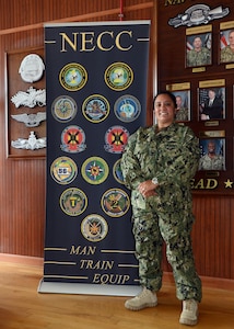 Personnel Specialist 1st Class Veronica Foley, from Beaumont/Port Arthur, Texas, stands on the quarterdeck of Navy Expeditionary Combat Command (NECC).