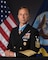 Britt Slabinski in uniform posing for the portrait with american and navy flags in the background