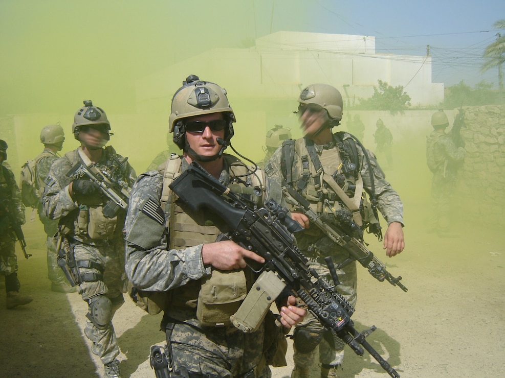 Monsoor on tour with his comrades walking through yellow smoke