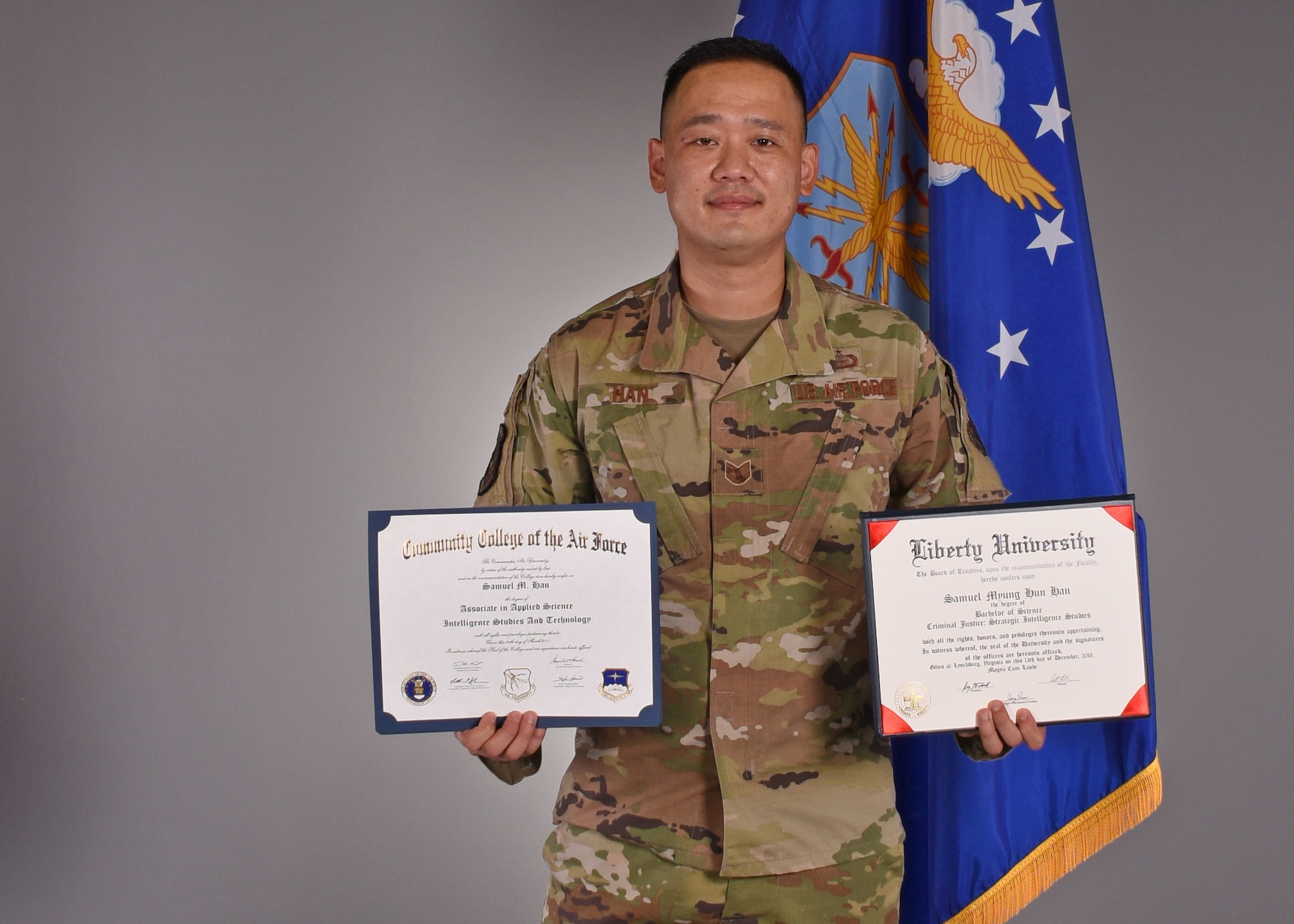 U.S. Air Force Tech. Sgt. Samuel Han, 316th Training Squadron instructor, displays two degrees he achieved while serving active duty, in the Public Affairs photo studio, on Goodfellow Air Force Base, Texas, July 15, 2020. Han’s life and Air Force career started out with adversity, but through positive mentorship, and actively seeking opportunities, he overcame his misfortunes. (U.S. Air Force photo by Airman 1st Class Abbey Rieves)