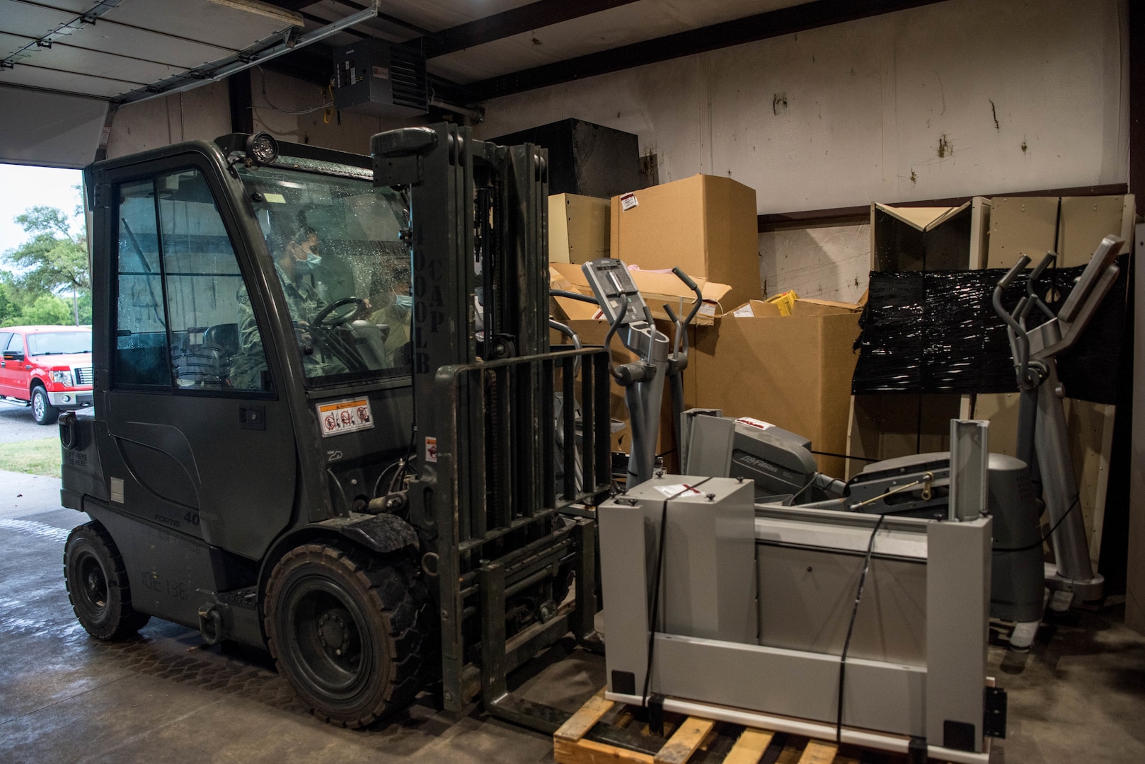 Airman 1st Class Krystal Bartling, 22nd Logistics Readiness Squadron flight services center journeyman, lifts a pallet of equipment to be processed July 16, 2020, at McConnell Air Force Base, Kansas. Last year the 22nd LRS flight services center repurposed $2.5 million in assets back into the DoD’s operational budget.  (U.S. Air Force photo by Airman 1st Class Marc A. Garcia)