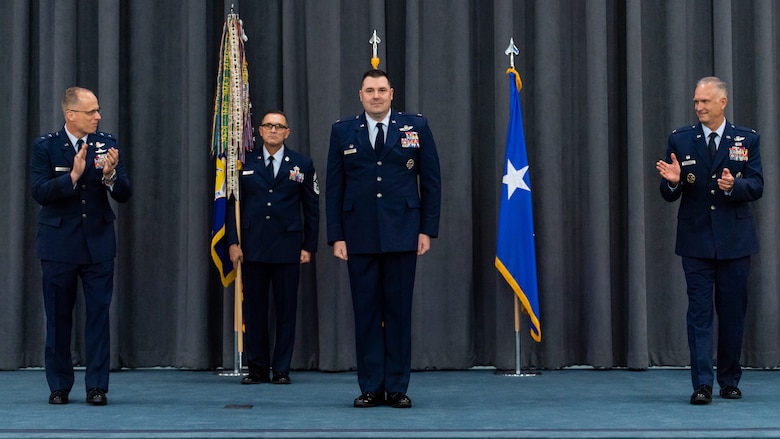 Maj. Gen. Mark E. Weatherington, left, 8th Air Force and Joint-Global Strike Operations Center commander, and Col. Michael A. Miller, right, outgoing 2nd Bomb Wing commander, congratulate Col. Mark C. Dmytryszyn, middle, incoming 2nd BW commander, during a change of command ceremony at Barksdale Air Force Base, La., July 23, 2020. A change of command is a military tradition that represents a formal transfer of authority and responsibility for a unit from one commanding or flag officer to another. (U.S. Air Force photo by Airman 1st Class Jacob B. Wrightsman)
