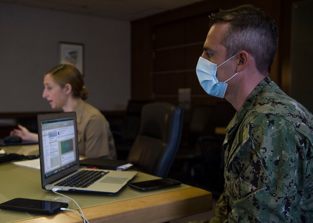 SINGAPORE (July 23, 2020) Lt. Carlos Prieto, intelligence officer assigned to Commander, Logistics Group Western Pacific, follows along as Lt. Claire Fitzpatrick, JAG assigned to Singapore Area Coordinator, presents a brief on maritime law during Southeast Asia Cooperation and Training (SEACAT) 2020. SEACAT promotes shared commitments to maritime partnerships, security and stability in Southeast Asia. This year, SEACAT takes shape as a virtual maritime domain awareness symposium with representatives from 22 participating nations.