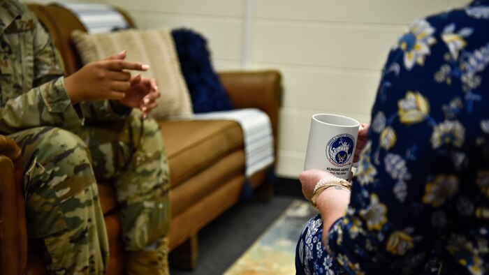 A photo of a military counselor speaking to an Airman.