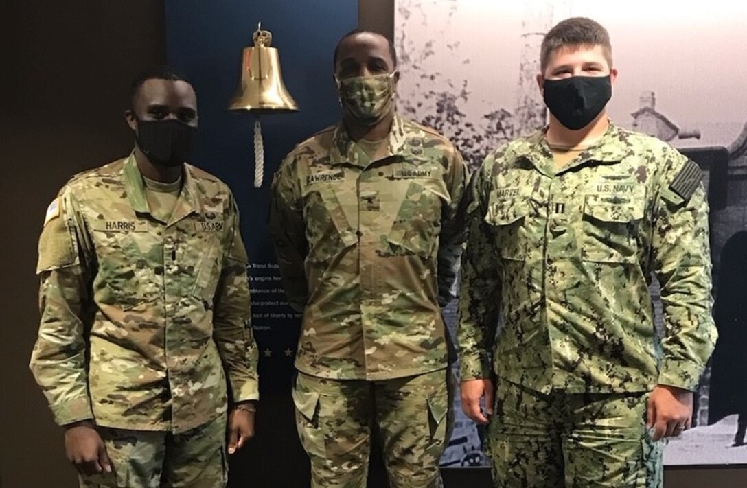 DLA Troop Support Commander Army Brig. Gen. Gavin Lawrence is flanked by 1st Lt. Brett Harris, left, and Navy Lt. Junior Grade Kevin Marvel, right, incoming and outgoing Aide de Camp to the Commanders, respectively, July 23, 2020 in the organization’s headquarters building in Philadelphia.