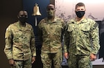 DLA Troop Support Commander Army Brig. Gen. Gavin Lawrence is flanked by 1st Lt. Brett Harris, left, and Navy Lt. Junior Grade Kevin Marvel, right, incoming and outgoing Aide de Camp to the Commanders, respectively, July 23, 2020 in the organization’s headquarters building in Philadelphia.