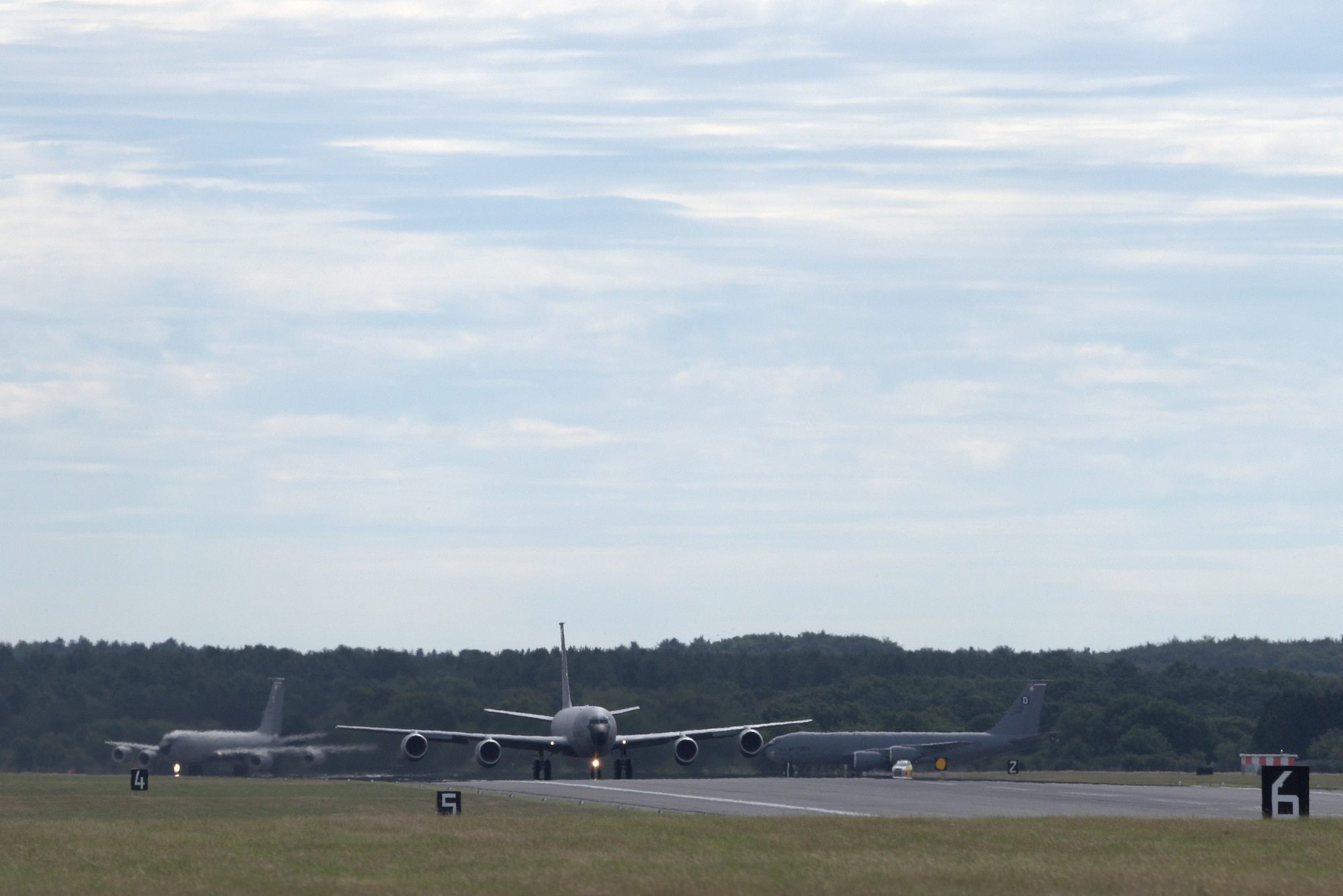 Three U.S. Air Force KC-135 Stratotankers, assigned to the 100th Air Refueling Wing, line up for takeoff at RAF Mildenahall, July 23, 2020. The 100th ARW provides unrivaled air refueling support throughout the European and African areas of responsibility. (U.S. Air Force photo by Senior Airman Benjamin Cooper)