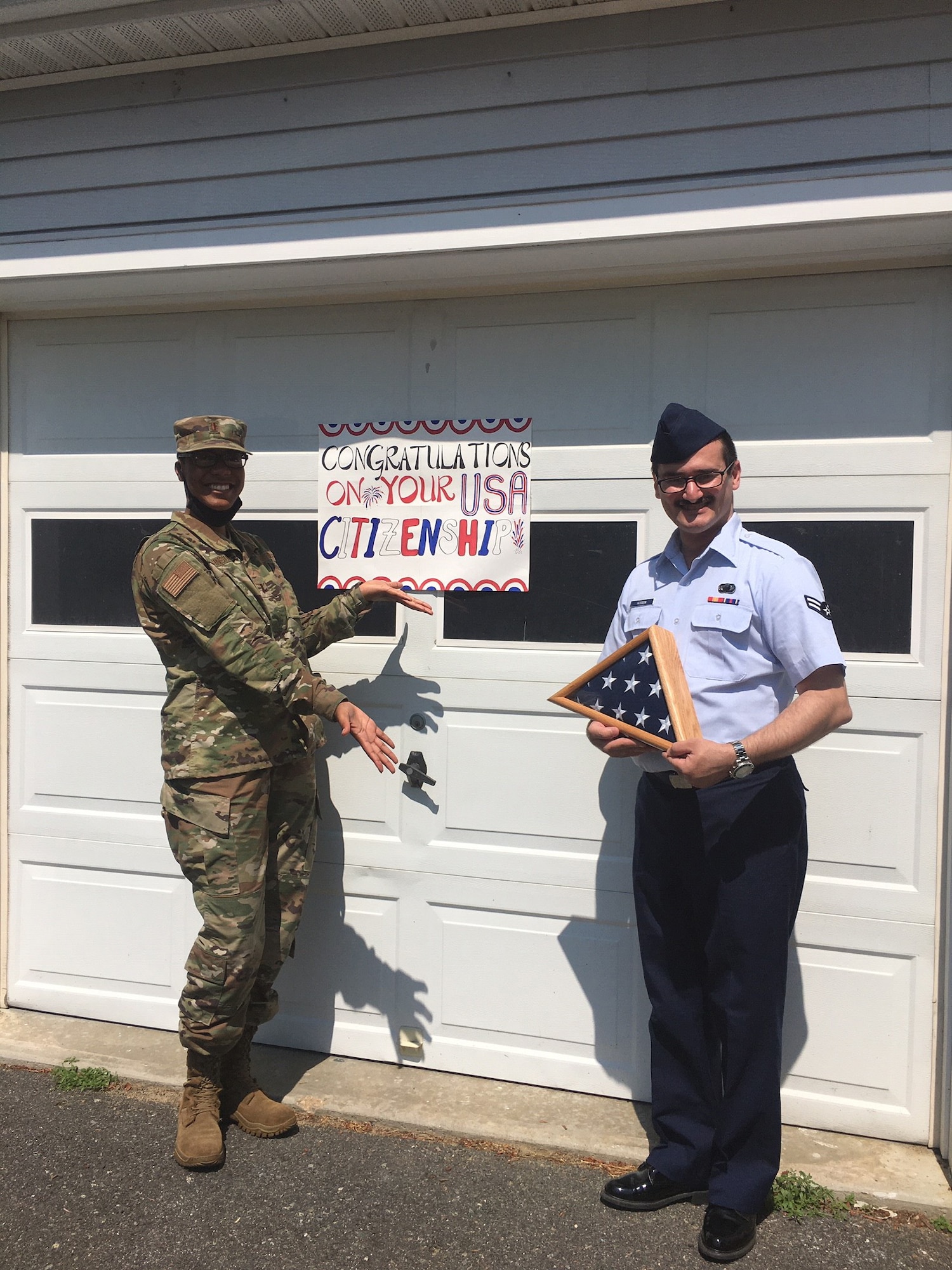 2nd. Lt. Judith Johnson, 66th Comptroller Squadron Financial Management Flight commander, surprises Airman 1st Class Aws Hussein, 66 CPTS financial management technician, after receiving his official American citizenship in Northampton, Mass., July 2. Originally from Baghdad, Hussein served alongside U.S. troops as a translator before moving to America with his family in 2013. (Courtesy Photo)