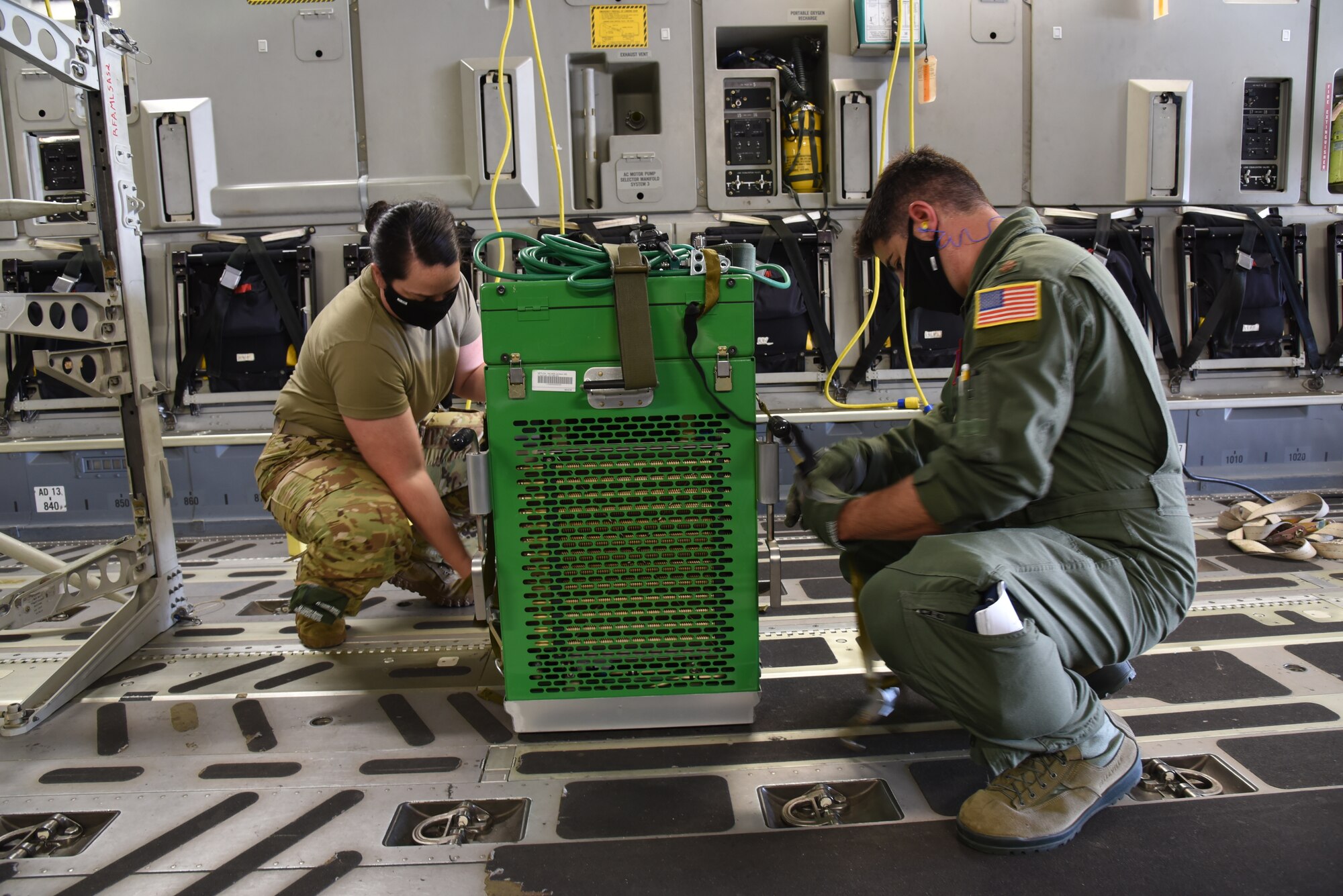 Maj. Michael McReynolds, 183rd Aeromedical Evacuation Squadron flight nurse, and Senior Master Sgt. Melissa Moseley, 183rd AES medical technician, secure the liquid oxygen cart used for patient therapeutic care while in flight. Reserve Citizen Airmen from the 36th Aeromedical Evacuation Squadron and Mississippi Air National Guardsmen from the 183rd AES came together for a three-day training event, July 20-22, 2020 at Keesler Air Force Base and the Mississippi Air National Guard's Combat Readiness Training Center in Gulfport, Mississippi. The training was a joint effort between Reservists and Guardsmen to work as one team, while training on patient care and handling during a simulated air evacuation of injured service members. (U.S. Air Force photo by Jessica L. Kendziorek)