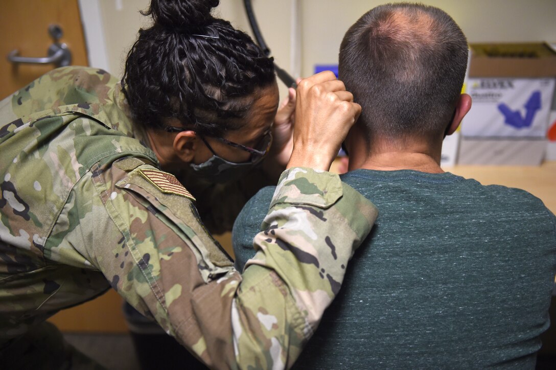 Staff Sgt. Brianna Suckoo, 62nd Medical Squadron Public Health technician, looks inside a patient’s ear before they take an audiogram hearing test at the McChord Clinic on Joint Base Lewis-McChord, Wash., July 21, 2020. Occupational health provides workplace hazard education and determines hazard-specific medical screening requirements for military and civilian personnel. (U.S. Air Force photo by Airman 1st Class Mikayla Heineck)