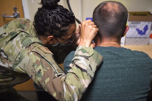Staff Sgt. Brianna Suckoo, 62nd Medical Squadron Public Health technician, looks inside a patient’s ear before they take an audiogram hearing test at the McChord Clinic on Joint Base Lewis-McChord, Wash., July 21, 2020. Occupational health provides workplace hazard education and determines hazard-specific medical screening requirements for military and civilian personnel. (U.S. Air Force photo by Airman 1st Class Mikayla Heineck)