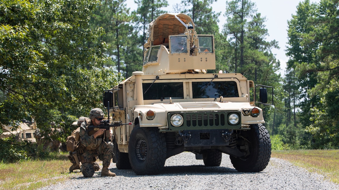 Cpl. James Bailey, 1st squad leader with Charlie Company, 3rd Platoon, Marine Corps Security Forces, U.S. Marine Corps Forces Command, Fleet Marine Force Atlantic, provides security after an ambush during a Mission Readiness Exercise (MRX) July 21, 2020, on Fort A. P. Hill in Port Royal, Virginia. Fleet Antiterrorism Security Team (FAST) platoons are required to execute a MRX prior to the FAST Deployment Program. The purpose of the MRX is to provide the training company with a mission-oriented and scenario based event, which will be evaluated by the regiment in order to validate each platoon’s proficiency in core mission essential task. (U.S. Marine Corps Photo by Sgt. Desmond Martin/Released)