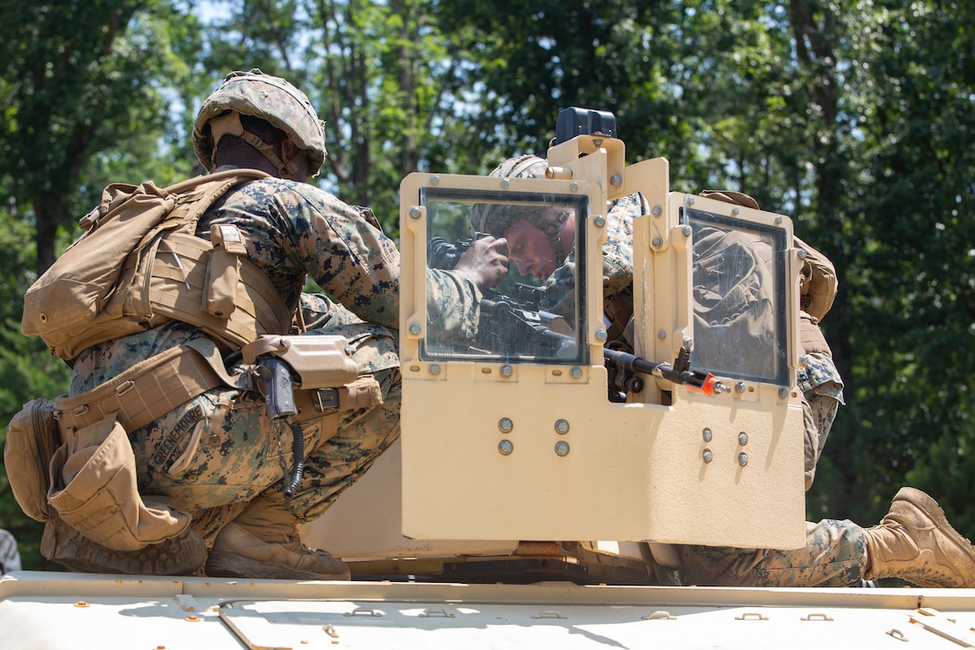 U.S. Marine Corps Lance Cpl. Tommy Greenemoore, left, and Lance Cpl. Joshua Stirek, riflemen with Charlie Company, 3rd Platoon, Marine Corps Security Forces, U.S. Marine Corps Forces Command, Fleet Marine Force Atlantic mount a M240 machine gun onto the turret of a Humvee during a Mission Readiness Exercise (MRX) July 21, 2020, on Fort A. P. Hill in Port Royal, Virginia. Fleet Antiterrorism Security Team (FAST) platoons execute MRX exercises prior to deployment to evaluate the platoons’ proficiency in core mission essential tasks. (U.S. Marine Corps Photo by Sgt. Desmond Martin/Released)