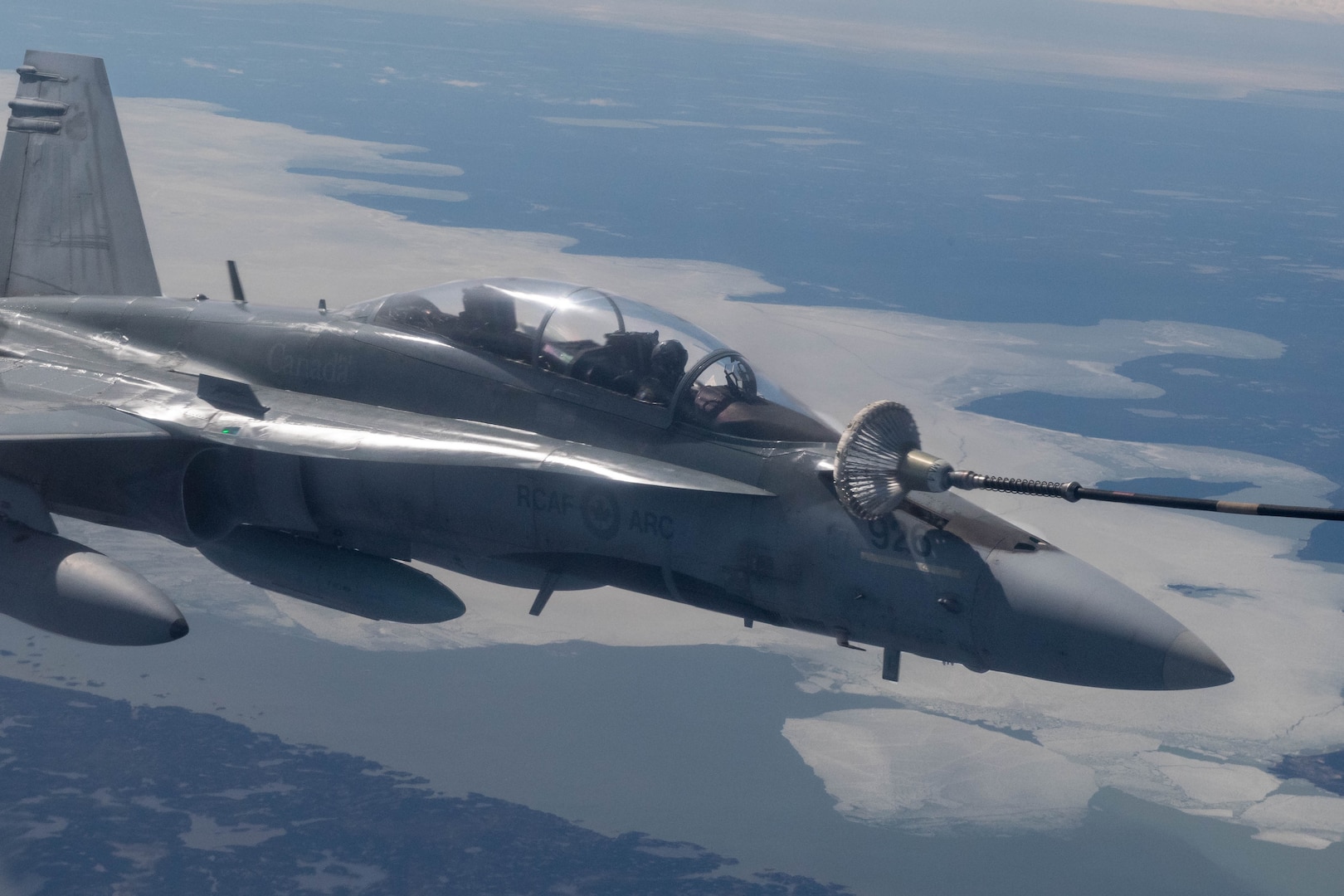 A CF-18 refuels with a CC-150T Husky Tanker during a NORAD Exercise in the arctic, June 14, 2020.