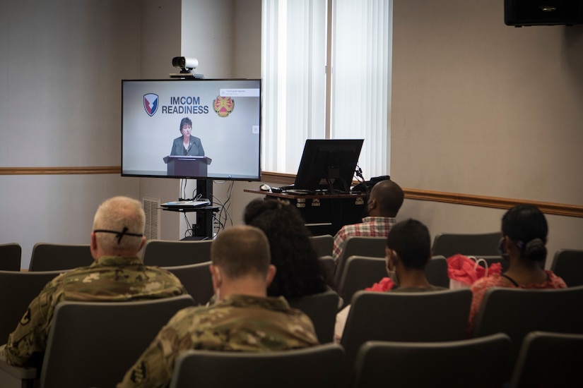 Photo of a civilian giving remarks during a change of command ceremony.