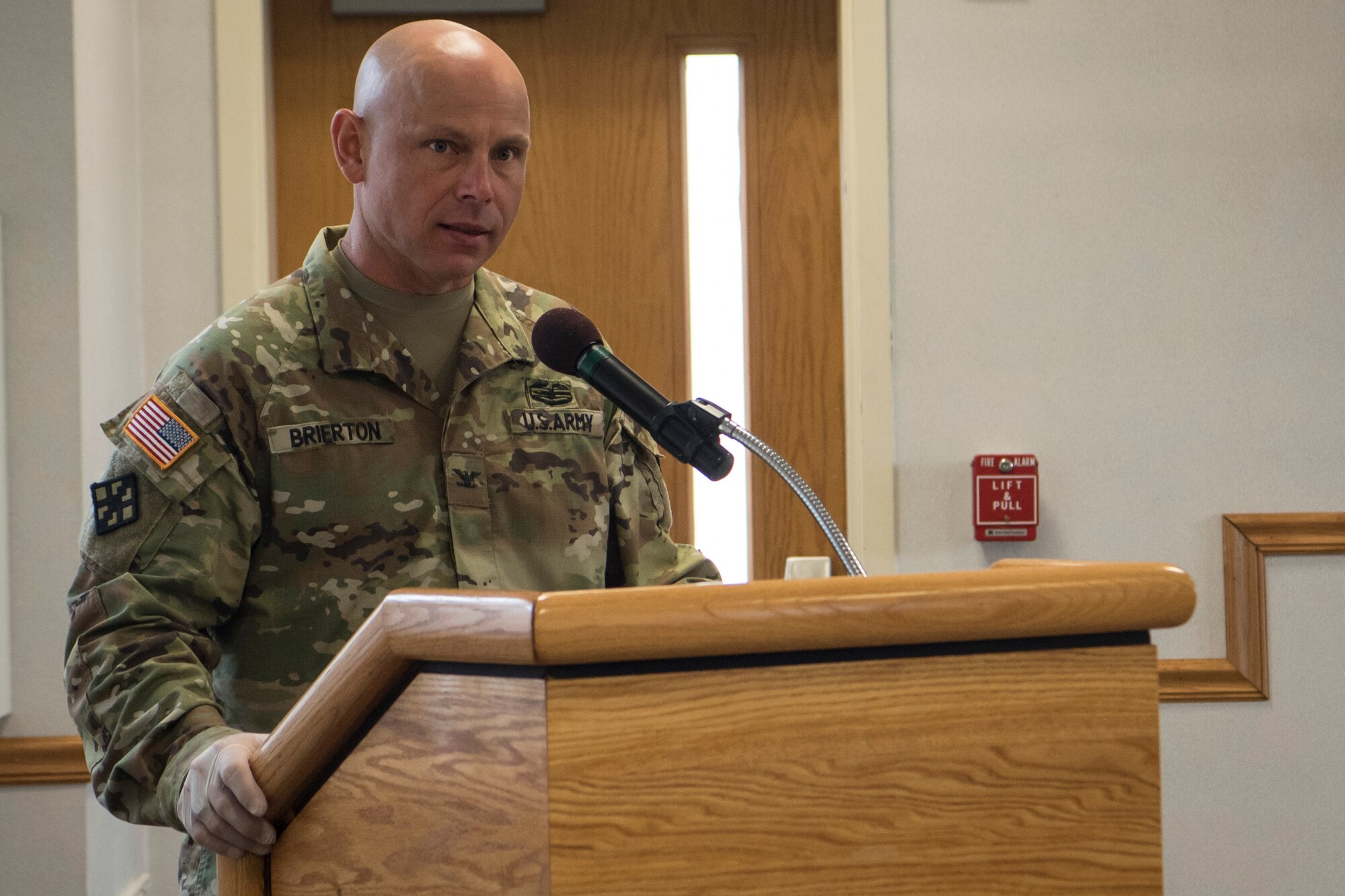 Photo of a soldier giving remarks during a change of command ceremony.